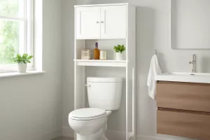 Modern over-the-toilet bathroom storage cabinet holding towels and toiletries in a small bathroom