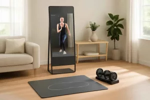 Modern home gym setup with smart workout equipment including interactive fitness mirror and app-connected dumbbells